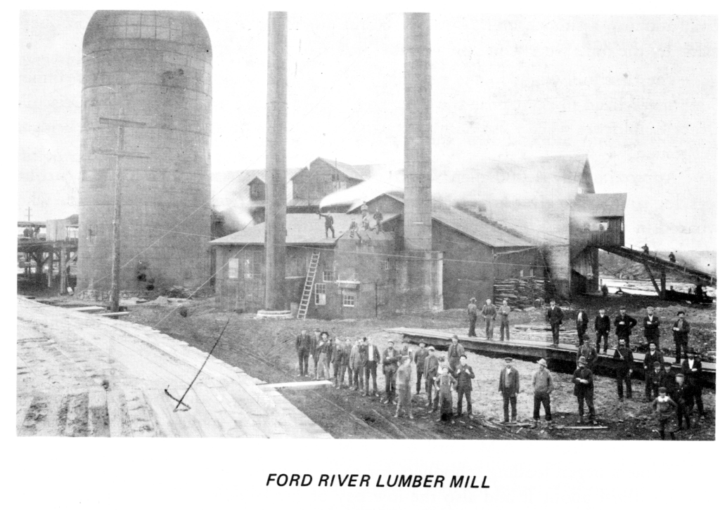 Historic Ford River lumber mill with workers.