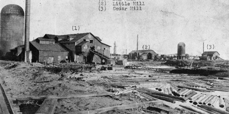 Historic Ford River saw mills with timber in foreground.